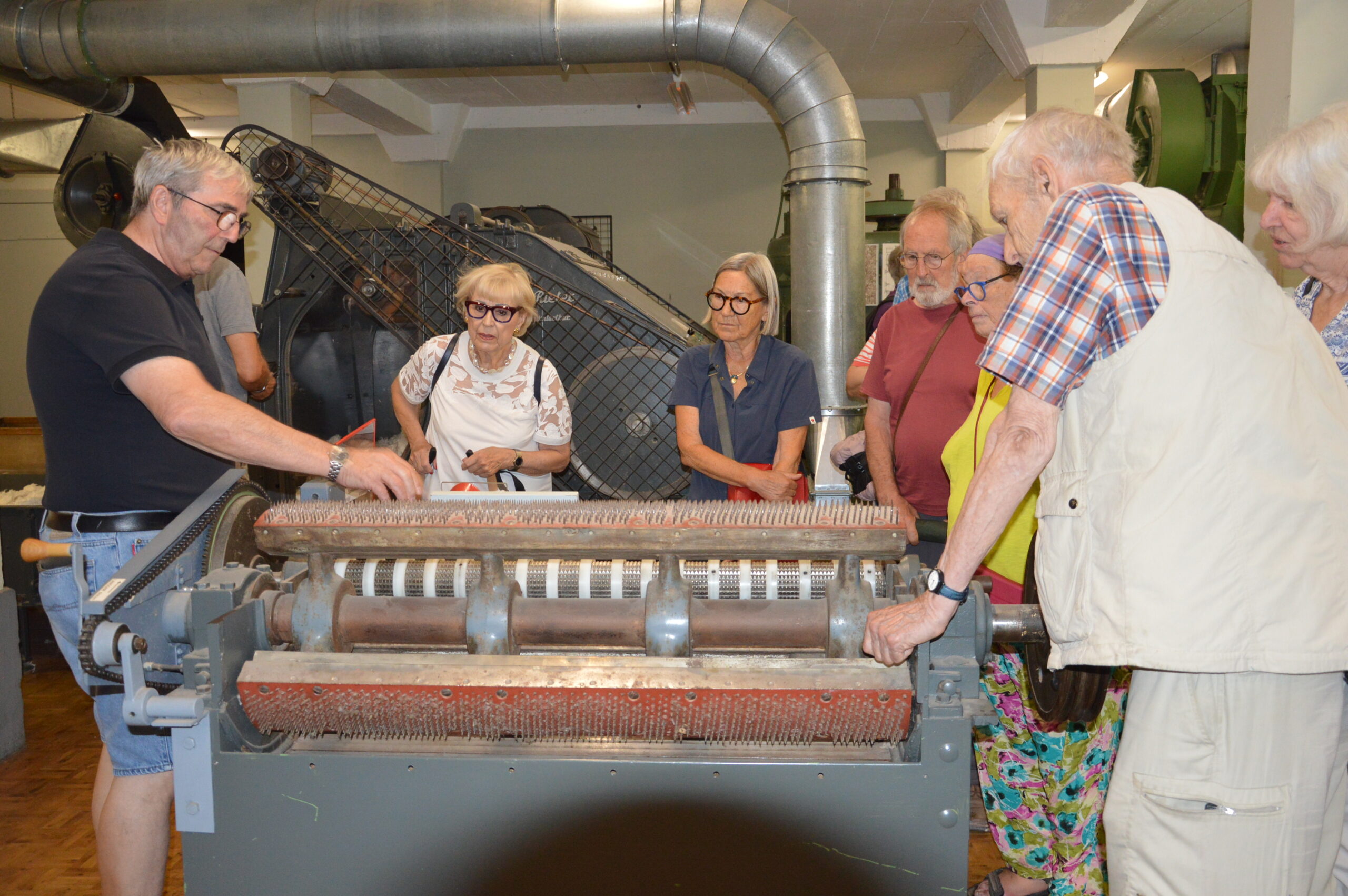 Besuchende folgen den Ausführungen von Walter Knuchel im Museum Neuthal.